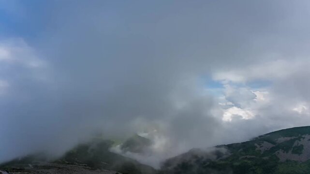 Time-lapse of cloud sea rolling over Qinling Taibai Mountain peaks under blue sky