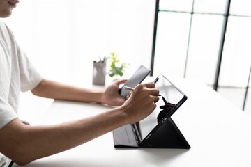Using stylus on tablet for digital note taking and productivity technology concept. © Charlie's