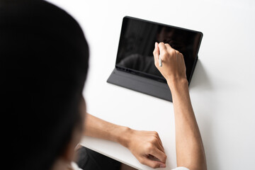 Using stylus on tablet for digital note taking and productivity technology concept. © Charlie's