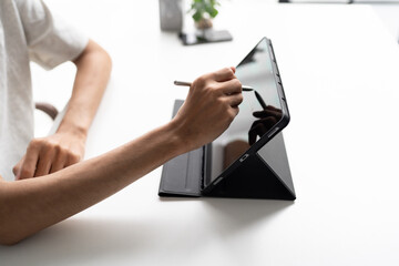 Using stylus on tablet for digital note taking and productivity technology concept. © Charlie's