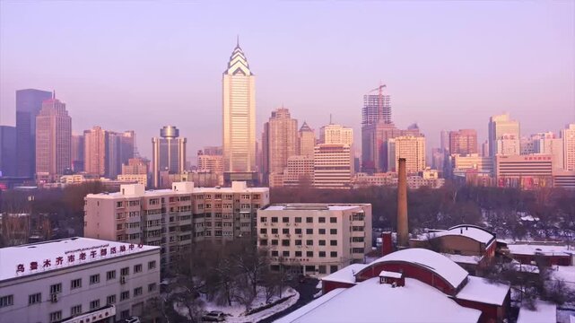 Urumqi city skyline at dawn with snow-covered rooftops and modern high-rises, winter urban landscape