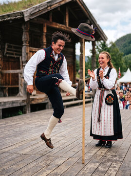 Norwegian dancers in traditional bunad performing the energetic halling dance