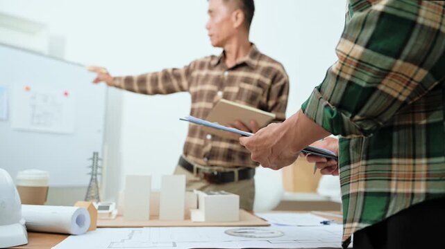 Two professional architects shake hands after signing a contract for a renewable solar energy project, finalizing the sustainable infrastructure deal