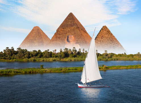 Beautiful Nile scenery with traditional Felluca sailing boat in the Nile on the way to Giza pyramids - Cairo, Egypt