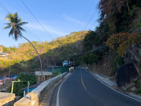 Winding Mountain Road Through Tropical Landscape