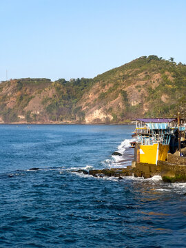 Coastal Landscape with Yellow Structure and Mountain