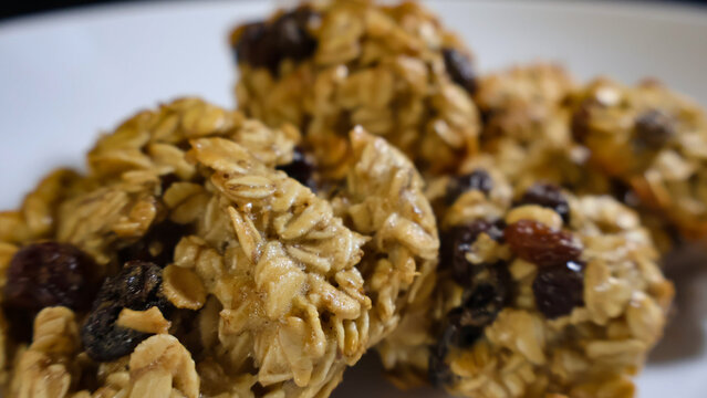 Homemade oatmeal cookies featuring rolled oats and plump raisins offer a healthy snack option or sweet dessert, perfect for a cozy morning or an afternoon treat