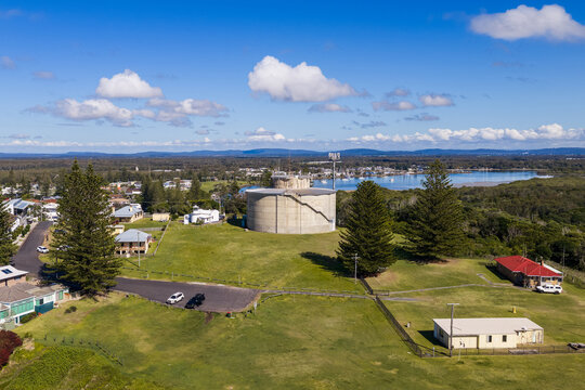 Description: Aerial view of the concrete water tank beside the replica of Yamba&rsquo;s original lighthouse on Pilot Hill, overlooking the coastal township in New South Wales, Australia.