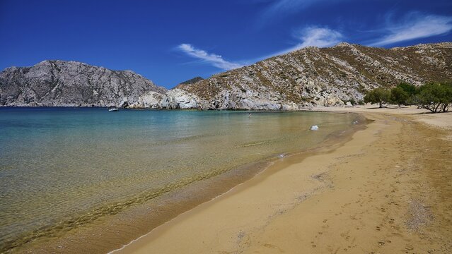 Long, unspoilt beach with turquoise water and mountains in the background, lined with trees, Psili Ammos beach, Patmos, Dodecanese, Greek Islands, Greece