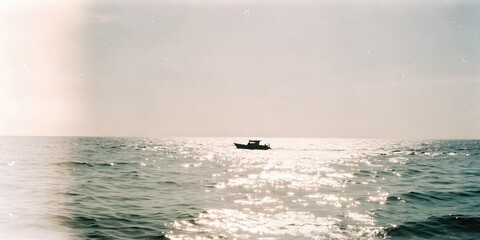 Obraz premium Small boat floating on shimmering ocean under sun