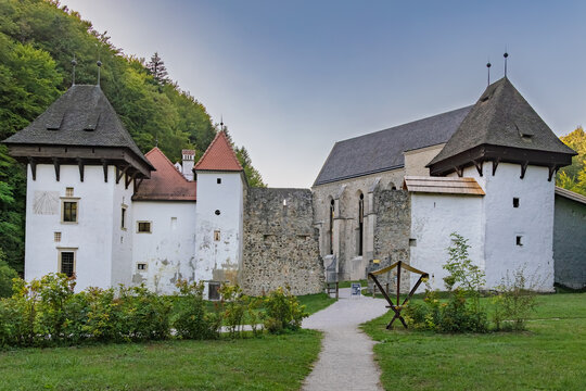 Historic medieval stone complex, defense towers, and monastery ruins of the Žiče Charterhouse (Žička kartuzija) surrounded by green forest in Slovenske Konjice, Slovenia