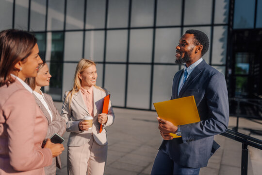 Diverse business professionals having informal outdoor meeting