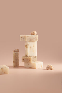 Handmade natural soap bar with seashell on beige background