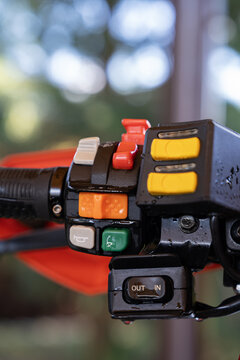 Close-up of wet motorbike handlebar control switches