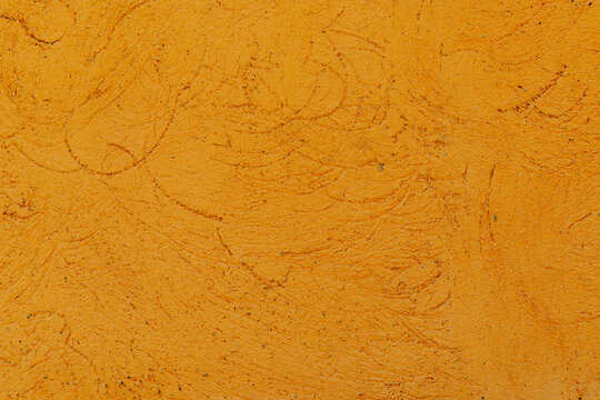 Orange stucco wall texture background with weathered detail