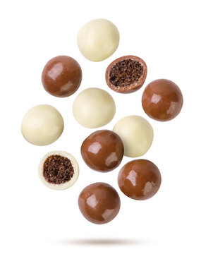 Chocolate balls and halves flying on a white. Isolated