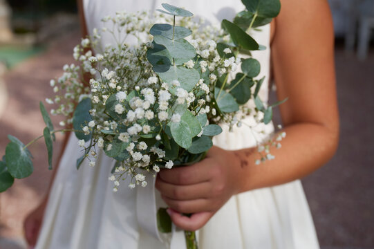 Girl hold eucalyptus and baby's breath bouquet