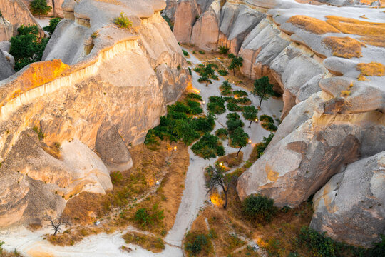 Narrow hiking trail winding through eroded volcanic rocks in Cappadocia