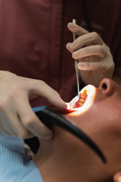 Dentist examining patient's teeth during oral check up
