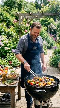 Man grilling skewers of vegetables and meat on a barbecue in a lush garden setting.