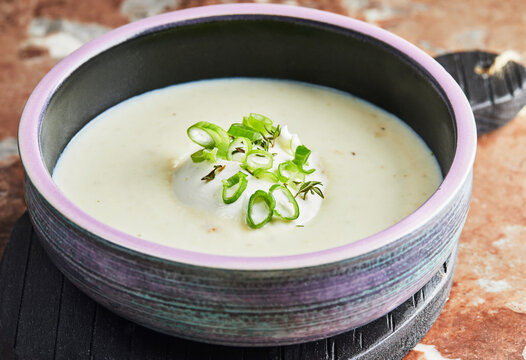 Cream Broccoli soup with green onions and sour cream. Healthy eating.