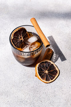 Spiced iced coffee with cinnamon and dried orange