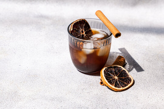 Spiced iced coffee with cinnamon and dried orange