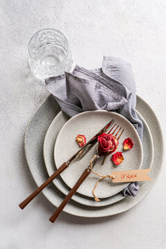 Dry red rose place setting with love tag and cutlery