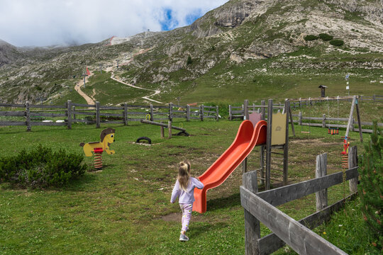 Dolomites mountain playground with child and alpine trail