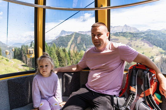 Toddler on cable car ride with Dolomites view