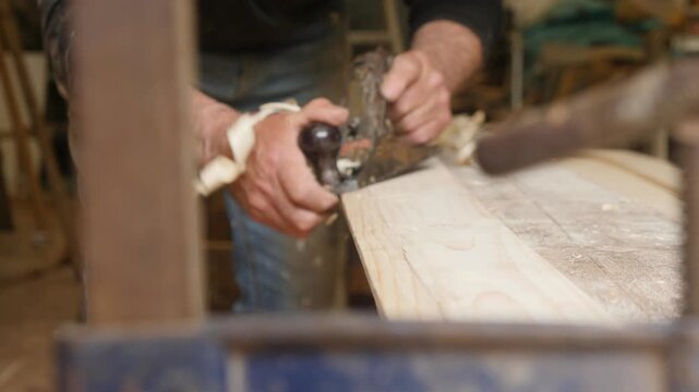 Hand planing plank creating bevel boat building