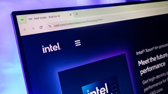 Intel website homepage displayed on a computer screen under neon purple lighting.