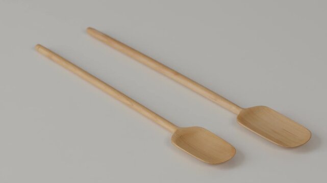 Two Natural Wooden Spoons on Neutral Background