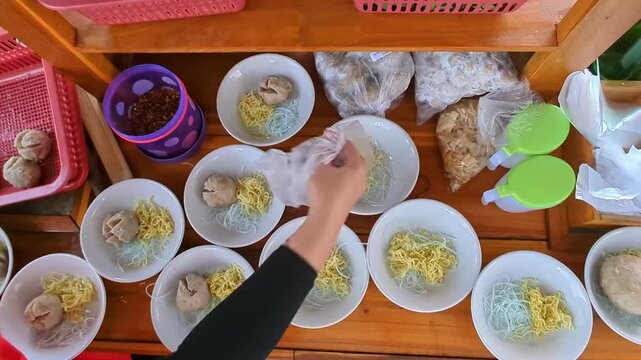 Indonesian meatball soup bowls with noodles vermicelli on wooden food stall