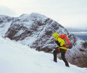 Fototapeta premium Hiker at a snowy Ben Nevis in winter