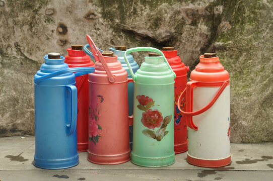 arrangement of vintage colorful chinese thermos flasks