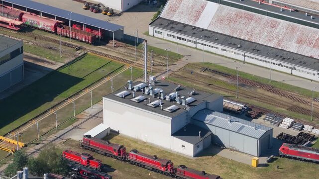 Aerial view of a railway depot with red locomotives and freight train wagons