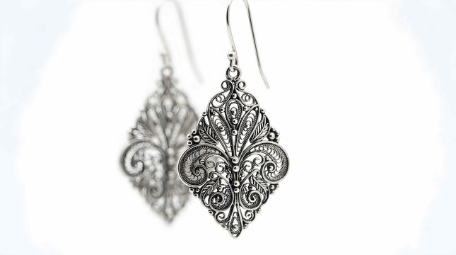 Elegant silver filigree dangle earrings with intricate metal scrollwork