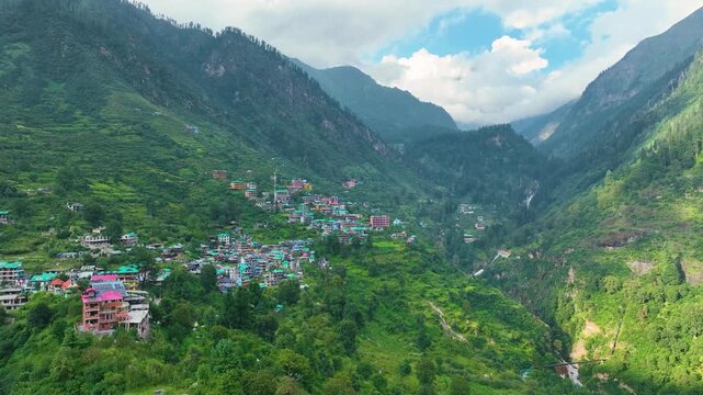 Drone view revealing the dramatic mountain topography and remote summer trekking infrastructure of Tosh in the Indian Himalayas.