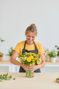 floristry apprentice creating flower arrangement