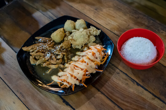 Crispy Fried Chicken with Creamy Sauce Salad and White Rice on Dark Plate