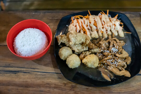 Crispy Fried Chicken with Creamy Sauce Salad and White Rice on Dark Plate
