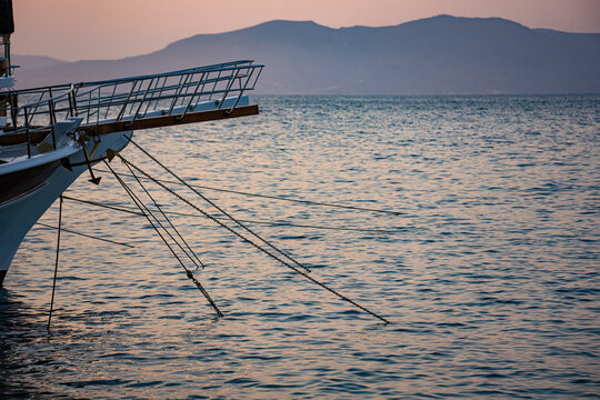 View of moored boat by the sea at sunset.