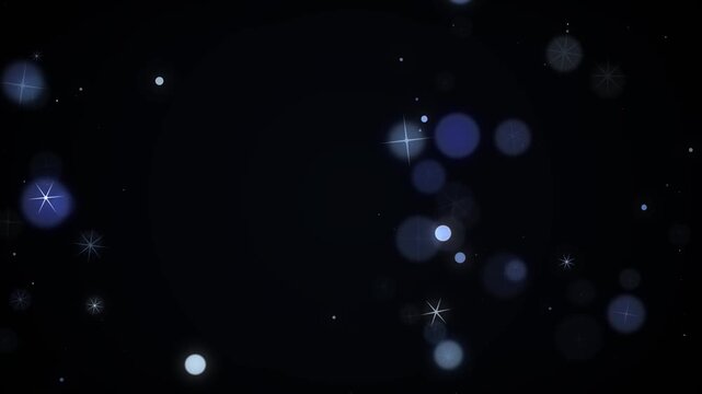 Magical sapphire blue sparkles and glowing star bokeh particles floating slowly across a dark background in motion