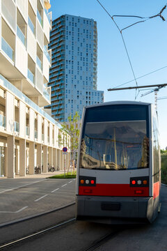 Tram moves along a residential urban street beside modern architecture in Nordbahnviertel Vienna Austria showing public transport and neighborhood mobility