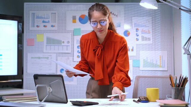 Businesswoman examining data and creating reports in a contemporary office setting