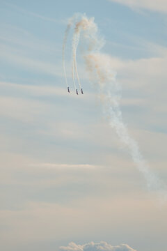 Aerobatic team performing synchronized stunt fly with smoke trails at Copernicus Airshow in Torun Poland