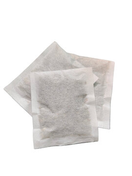 "Minimalist composition of organic herbal tea bags stacked on a clean white background, highlighting a healthy, natural, and calming lifestyle."