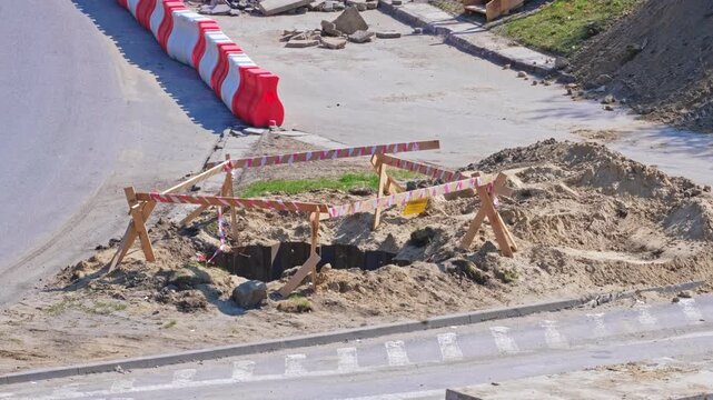 Roadworks Construction Site Overpass Pillar Foundation Excavation Pit Secured with Metal Wall Wooden Barrier and Safety Tape