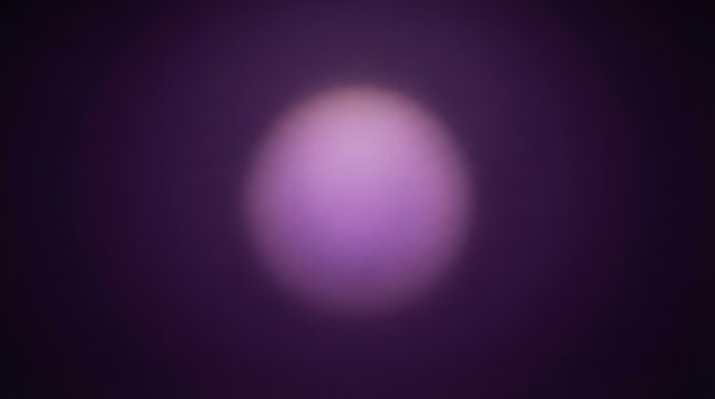Blurred purple light orb on a dark background creating an abstract and mysterious visual effect.